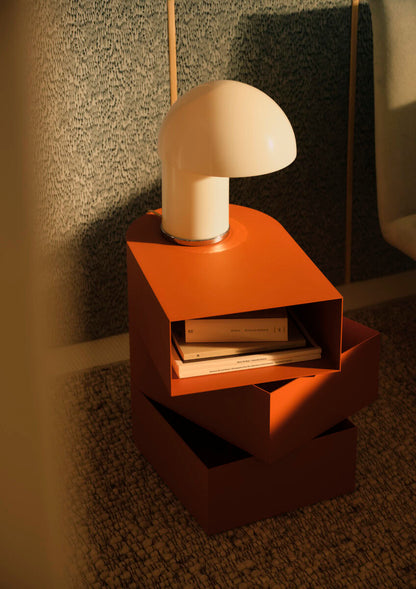 Bolzan Abside tall bedside table in RAL 8023 Brown-orange; lamp and books not included.