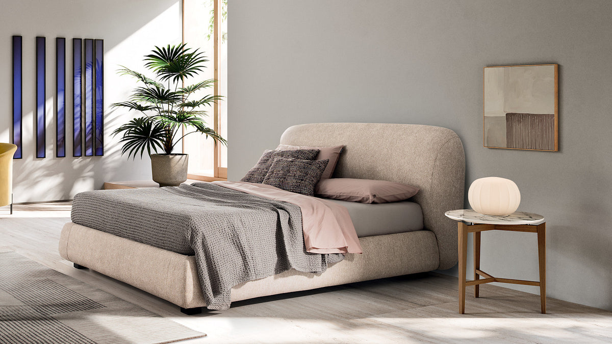 Calligaris Noa bed in an interior. Finish, mattress, bed linen and accessories are illustrative.